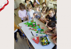 Dzeci tworzą wspólną pracę plastyczną